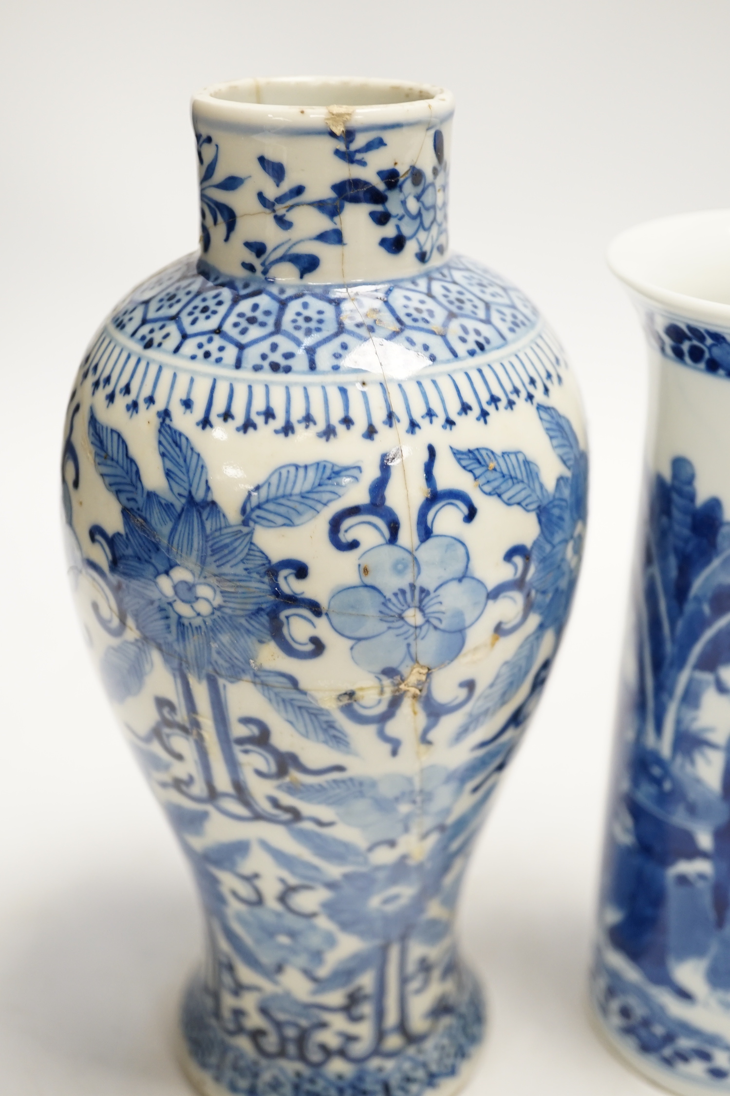 Two early 20th century Chinese blue and white vases, one restored, 23cm